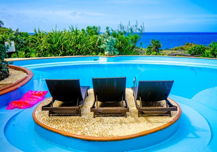 Spacious hut suite at Great Huts eco resort in Portland Jamaica with sitting area and art pieces