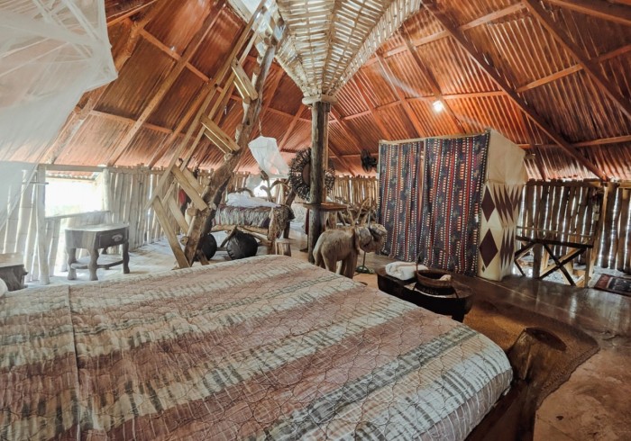 Spacious hut suite at Great Huts eco resort in Portland Jamaica with sitting area and art pieces