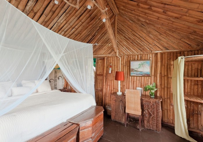 Spacious hut suite at Great Huts eco resort in Portland Jamaica with sitting area and art pieces