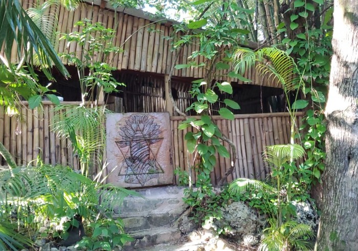 Spacious hut suite at Great Huts eco resort in Portland Jamaica with sitting area and art pieces